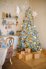 Decorated winter fir tree with lights and gifts in warm room setting