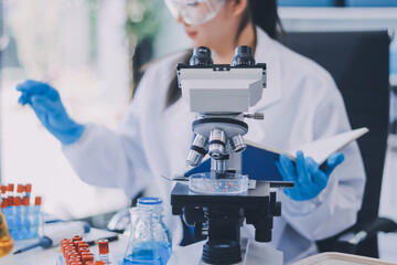 Fototapeta premium Portrait, science and happy woman on laptop in lab to research chemistry, test or innovation. Microscope, scientist and face of medical doctor in goggles for microbiology, healthcare or pharma study
