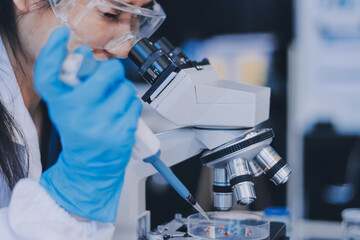 Portrait, science and happy woman on laptop in lab to research chemistry, test or innovation. Microscope, scientist and face of medical doctor in goggles for microbiology, healthcare or pharma study