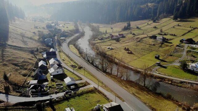 Lonely woman walks alone on the road in a rural village in Eastern Europe