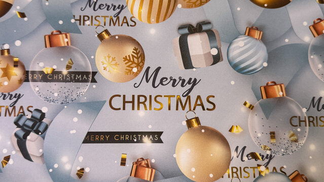 A festive Christmas background with gold and blue ornaments, gift boxes, confetti, and &ldquo;Merry Christmas&rdquo; text on a soft winter backdrop, perfect for holiday designs
