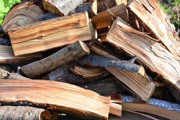 a close up of Pile of Split Firewood Logs Ready for Winter