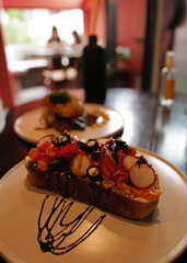 Close up smoked salmon on toast topped with radish and black olive