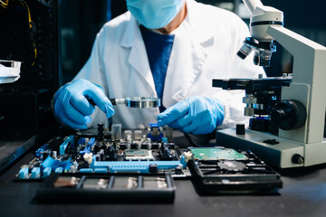 Closeup of expert soldering a green PCB board using precision tools. Ideal for electronics, circuit repair, engineering, tech
