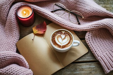 Cozy autumn morning with coffee and candle