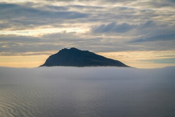 Majestic mountain peak emerging from a sea of clouds