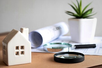 Real estate inspection tools and model house on a table