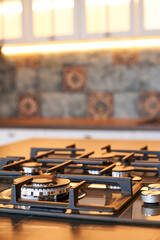 Close-up of the gas control knob on a modern gas stove.