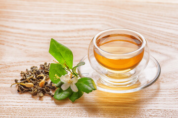 Jasmine green tea in clear cup on wooden table