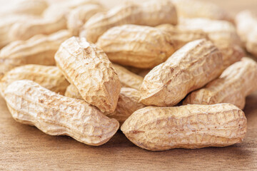 Closeup view of fresh peanuts on wooden table