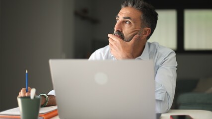 Man solving problem thinking working on laptop