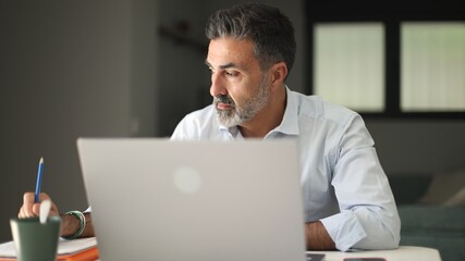 Mature man working remote office having concentration