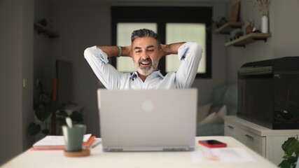 Relaxed businessman enjoying remote work at home
