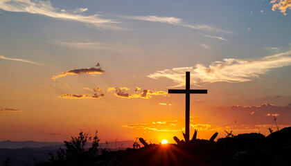 Cross of Jesus Christ silhouetted against dramatic sunset sky. Christian symbolism, Easter concept.