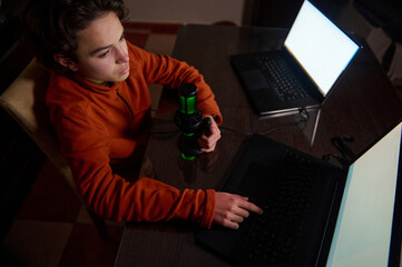 Focused Teen Recording Podcast At Home Office With Laptop And Microphone