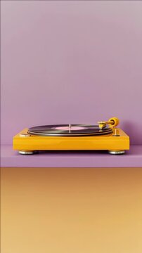 Vintage analog record player with yellow base and a pink wall in the background. Headphones laid across it indicate audio quality and music listening enjoyment.