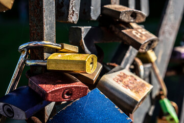 colorful love locks hanging on the fence