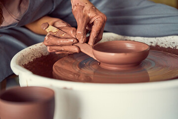 Potter Shaping Wet Clay on a Spinning Wheel, Focused Hands Creating Ceramic Vessel