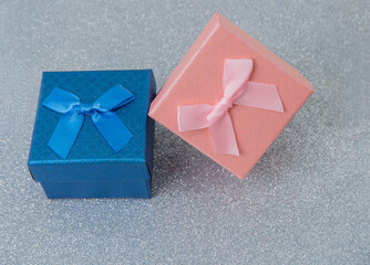Colorful gift boxes with ribbons on shiny surface
