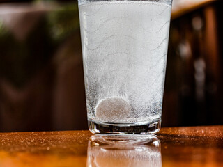 A photo of the bubbles seen when an effervescent tablet is dropped into a glass of water.