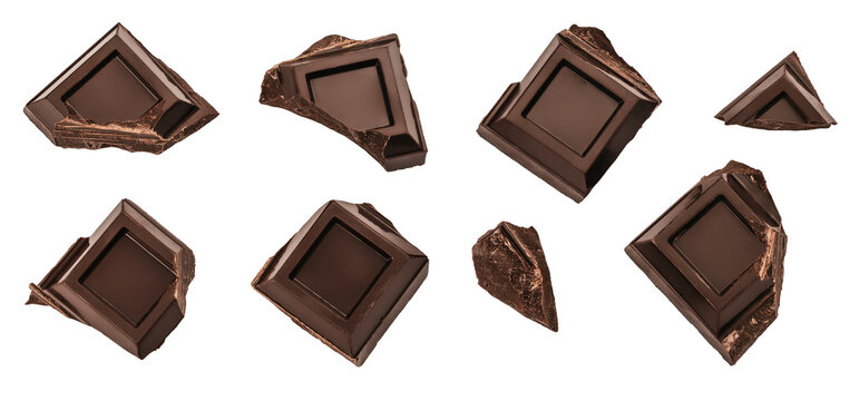 Scattered broken dark chocolate squares isolated on white background with copy space, premium dessert concept