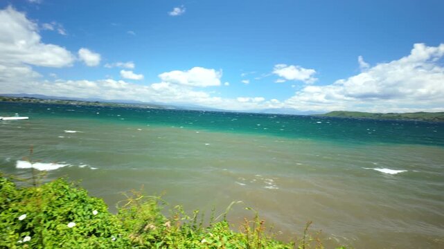 Windy lake view from green hill