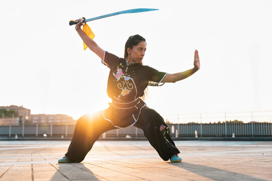 Chinese young woman practicing wushu kung fu.