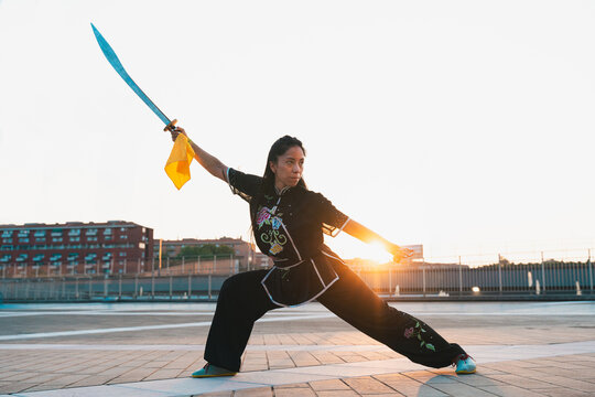Chinese young woman practicing wushu kung fu.