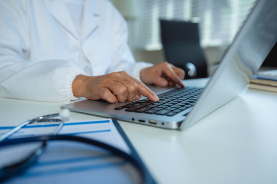 Medicine doctor woman hand working with modern digital   Laptop computer interface as medical network concept. - Powered by Adobe