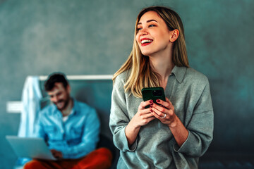 Cheerful caucasian couple enjoying digital communication and social interaction, they relax at home