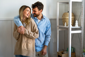 Young diverse couple moving in new home. Couple is having fun in new house at moving day