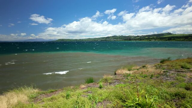 Windy lakeside landscape with blue waves