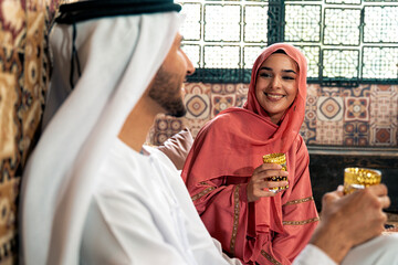 Young couple from Emirati spending time in a cafe