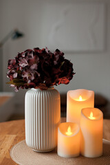 Cozy autumn home interior with warm candlelight and LED decor creating a calm hygge atmosphere