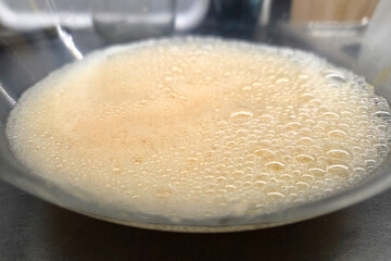 Close-up of Frothy Liquid in Transparent Bowl for Culinary and Beverage Use