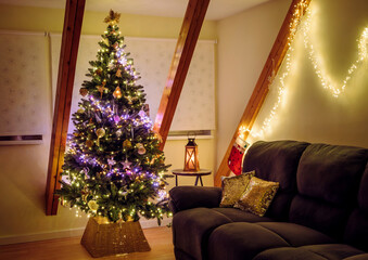 A basketweave Christmas tree collar with pink and yellow string lights illuminating the Christmas tree, decorated with fantasy-themed ornaments at home at night.