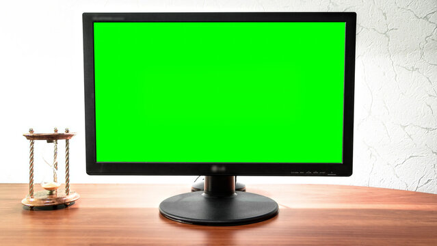 Computer green screen monitor is standing on a desk in an office timelapse hyperlapse. - Powered by Adobe