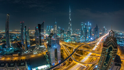 Modern skyscrapers and busy evening highways day to night timelapse in luxury Dubai city, Dubai,...