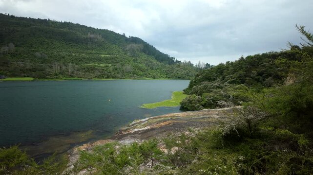 Lake Shore And Green Hills In Geothermal Valley New Zealand