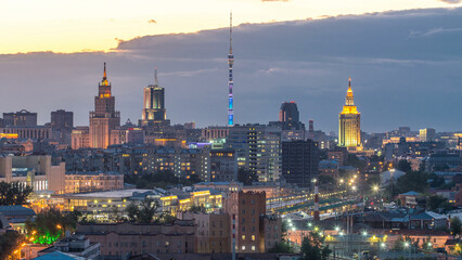 Fototapeta premium Ostankino tv tower and stalin skyscrapers near railway station day to night timelapse. Moscow, Russia