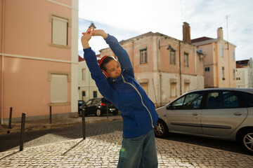 urban jogger portrait, candid snapshot of individual gearing up for exercise on bright urban morning