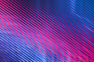 Close-up of diagonal metallic ridges illuminated with vibrant pink and blue neon light, abstract pattern