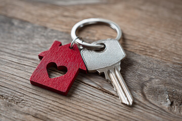 Red home keychain symbolizing real estate property