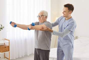Doctor therapist aids a senior patient during physiotherapy, guiding arm joint stretching exercises for rehabilitation. Therapeutic session helps improve movement and supports joint health.