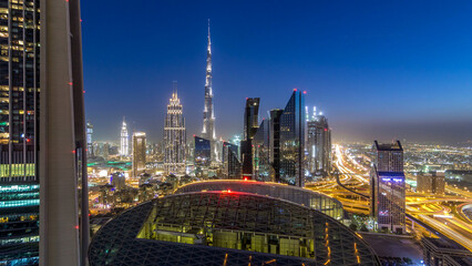 Dubai downtown skyline day to night timelapse with tallest building and Sheikh Zayed road traffic,...