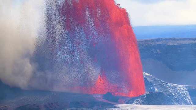 Aerial view of vibrant red lava cascading dramatically in Kilauea, contrasting with the dark landscape and plumes of white smoke, Kilauea, Hawaii, United States.