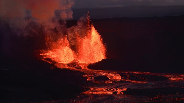 Aerial view of the fiery Kilauea volcano erupting with molten lava contrasting against the dark landscape, Kilauea, Hawaii, United States.