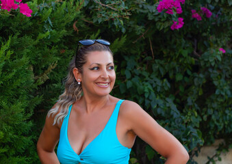 portrait of a beautiful young woman smiling at camera in the garden	