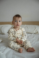 Portrait Joyful baby in bear print pajamas