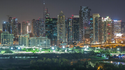 Jumeirah lake towers skyscrapers and golf course day to night timelapse, Dubai, United Arab Emirates